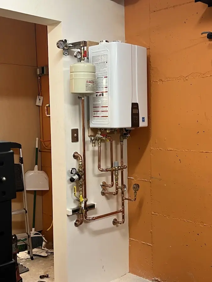 Plumbing technician inspecting water heater connections in Starke